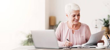 Olgun düzenleyici yazdırılmış metni okur, notlar alır, dizüstü bilgisayar kullanır, evden çalışır, boşluğu kopyalar