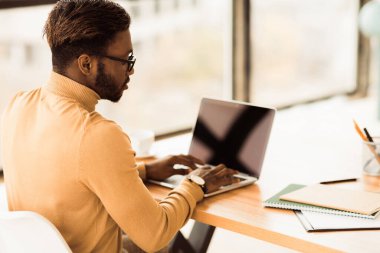 E-postaları kontrol ediyorum. Afro iş adamı öğrenmesi, dizüstü bilgisayarda çalışması, ağ defteri, telif alanı uygulamaları