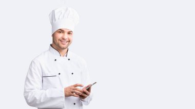 Culinary App. Smiling Chef Man Using Smartphone Standing Over White Studio Background. Panorama