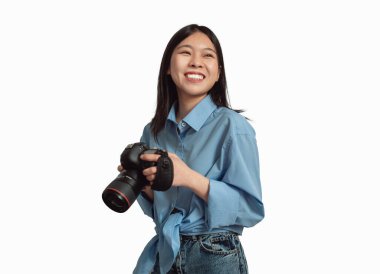 Happy Japanese Photographer Lady Posing Holding Photo Camera Over White Studio Background. Professional Creative Photography Career And Education Concept. Isolated