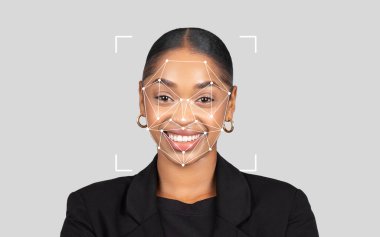 Afro-Amerikalı bir kadın gülümserken dijital yüz tanıma programı onun özelliklerini tarafsız bir arkaplan ile örtüyor..