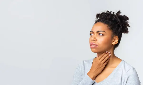 stock image Upset afro woman having pain in her throat, touching neck, panorama with copy space