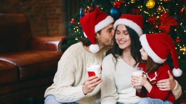 Noel Baba şapkalı neşeli bir aile Noel arifesini evde birlikte geçirir, süt içer, annemi öperdi.