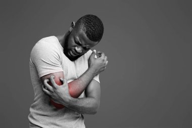 Insect bite allergy. Young afro man scratching his itching hand, white background, copy space