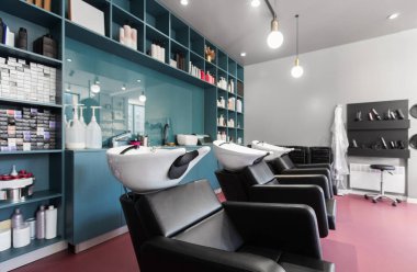 Interior of european beauty salon. Hairdresser places and many professional cosmetics on shelves