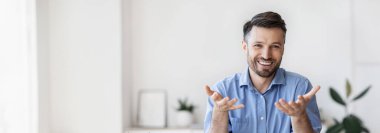 Başarılı yakışıklı iş adamı ofisinde oturuyor, kameraya konuşuyor, deneyimini ve fikirlerini paylaşıyor, boş alan yaratıyor.