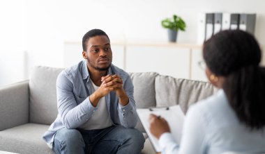 Psikolojik yardım servisi. Ruh sağlığı kliniğinde psikoterapi gören depresyondaki siyah bir hasta. Duygusal sorunları olan genç bir adam profesyonel terapiste danışıyor.