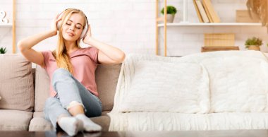 Young Girl Enjoying Music With Closed Eyes, Using Wireless Earphones at Home, Copy Space