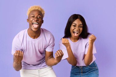 Efsanevi Afro-Amerikan çifti zafer için mutlu ya da leylak arka planda başarılı diye bağırıyor.