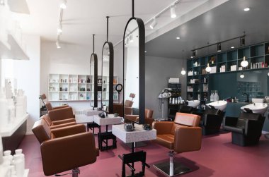 Stylish beauty salon interior. Hairdresser and makeup artist workplaces in one room, creative mirrors