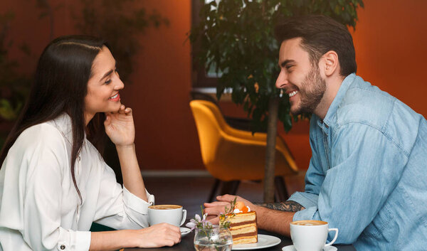 Romantic Date. Millennial Couple In Love Talking And Smiling Each Other Sitting In Coffee Shop Cafe.