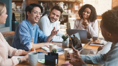 Close up of young creative international group of people having business meeting in office