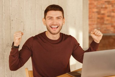 İş Başarı. Modern Ofiste Terfi Kutlaması İçin Dizüstü bilgisayarda Oturan Mutlu Adam Yumrukları. Seçici Odaklanma