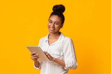 Modern Technologies For Life. Portraif Of Smiling African American Woman Holding Digital Tablet And Looking At Camera, Yellow Background, Panorama