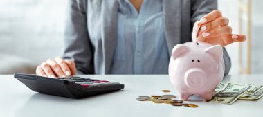 Girl in protective mask saves money in bank pig during quarantine clipart