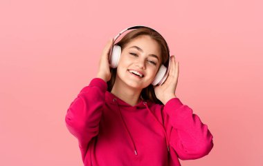 Rahatlayın ve müzik. Kablosuz kulaklıklı genç kız favori şarkının tadını çıkarıyor, yakın plan, stüdyo çekimi.