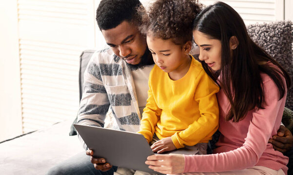 International family looking at tablet at home, during quarantine