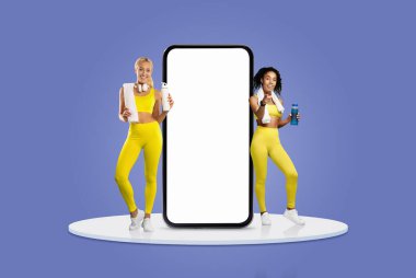 Two women dressed in bright yellow activewear display healthy products, showcasing their fitness routine and lifestyle, alongside a large blank smartphone for promotional purposes. clipart