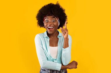 Harika bir fikrim var. Heyecanlı Afrikalı Kadın Parmağını Parmakla Gösteriyor Eureka Anı Pembe Stüdyo Arkaplanının Üzerinde Duran Kameraya Gülümsüyor. Yaratıcılık ve İlham Konsepti