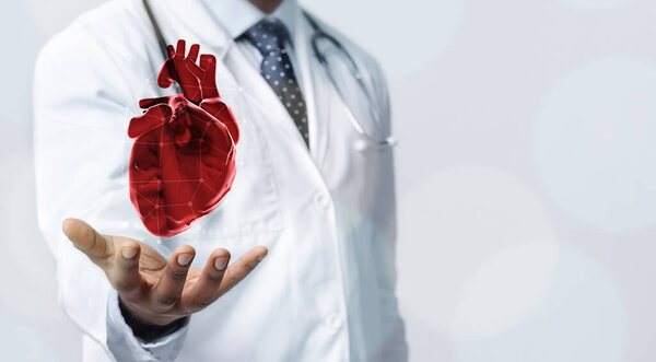 Healthcare Concept. Closeup of doctor in white coat holding virtual heart in open palm, copy space