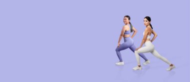 Two women pose in stylish workout outfits against a pastel background, showcasing their fitness routines and promoting an active lifestyle. They exude confidence and energy. clipart