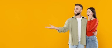 Genç bir çift sevgisini ve sevgisini neşeli bir şekilde ifade eder. Birbirlerine gülümserler, birlikte mutlu bir anın tadını çıkarırlar. Parlak, neşeli bir arka plana karşı, kopyalama alanı.