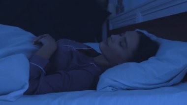 Uyku bozukluğu. Yatakta dönüp duran genç kız, uyuyamıyor.