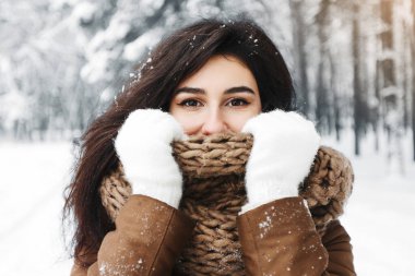 Kış havası. Karlı Ormanda Durarak Atkıyı Isınmaya Çalışan Genç Kadın