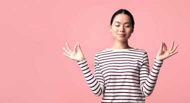 Zen. Relaxed Peaceful Asian Woman Meditating With Closed Eyes, Calm Young Korean Female Practicing Yoga, Keeping Hands In Mudra Gesture, Standing Isolated Over Pink Background, Copy Space clipart