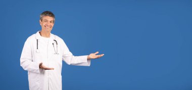 A mature male doctor in a white coat stands confidently with a warm smile. He gestures invitingly, showcasing his approachable demeanor, copy space clipart