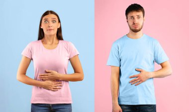 Young female and male touching stomaches, feeling satiety after eating hearty meal, biting lips, having good appetite clipart