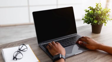 Dizüstü bilgisayarı olan tanınmayan siyah bir kadın evinde yeni bir alışveriş sitesi kullanıyor, tasarım için bir model. Genç Afro bayanın web mağazasından, kapalı mekanlardan mal aldığı yakın plan. Günlük yaşamda modern teknolojiler