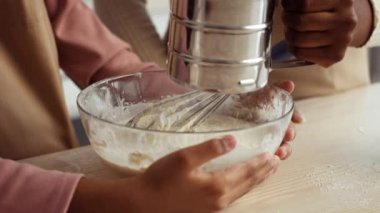 Bir anne ve küçük kızı mutfakta kaliteli vakit geçirmekten zevk alıyorlar, hamur işleri için malzemeleri karıştırıyorlar. Kahkaha ve neşe yemek yaparken havayı doldurur..