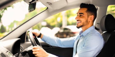 Resmi kıyafetli neşeli sakallı adam yola bakıyor ve gülümsüyor, güzel bir otomobil sürüyor, genç orta doğulu iş adamı ofise gidiyor, yan görüş, fotokopi odası, güneş ışığı...