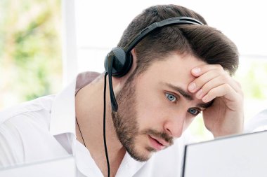 Çağrı merkezinde müşteri şikayetiyle uğraşan sinir bozucu bir telefon operatörü. Genç teknik destek danışmanı modern açık uzay ofisinde müşteri talebi çözmede sorun yaşıyor