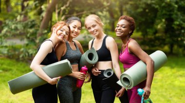 Parktaki spor dersinden önce yoga minderli çeşitli kızların portresi.