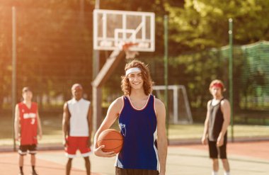Yakışıklı milenyum oyuncusu ve çok uluslu takımı dışarıda basketbol oynamaya hazır.