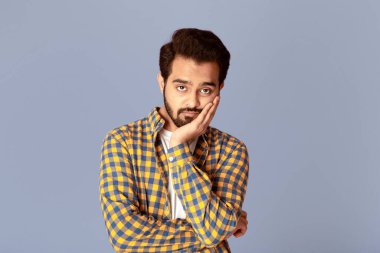 Yakışıklı Hintli bir adam kendini sıkılmış ya da yorgun hissediyor.