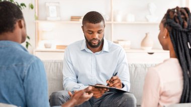 İlişki sorunları olan Afrikalı Amerikalı bir çift danışman, erkek psikoterapist not alıyor, terapi seanslarında genç bir aileyle bilgi topluyor, boş alan arıyor.