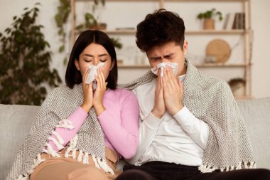 Hasta Asyalı çift üşümüş, burunlarını sümkürmüş, kağıt mendile hapşırmış, evde kendilerini kötü hissediyorlar. Rhinitis ve Mevsimsel Alerji, Grip Hastalığı. Hasta Aile Kendini İzole Etme Konsepti