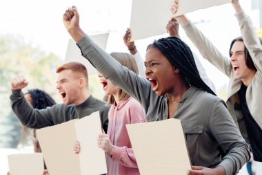 Sokaktaki hükümet binasının yanında sloganlar atan, 2021 tecrit kısıtlamasına karşı grev yapan, boş pankartlarla binlerce yıllık öfkeli protestocuların yan görüntüsü