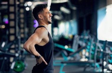 Spor Travması. Genç Arap erkek sporcu spor salonunda antrenman sırasında bel ağrısından muzdarip, Orta Doğu sporcusu Ache 'ye masaj yapıyor ve Ache ile çığlık atıyor, Bel omurgasından yaralanmış, Boşluğu Kopyala