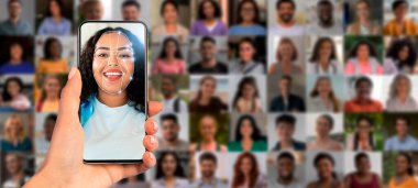Bir kişi elinde akıllı telefonu tutuyor, ekranda gösterilen farklı kişileri tanımlamak için yüz tanıma teknolojisini kullanıyor, tanımlama teknolojisindeki modern gelişmeleri vurguluyor..
