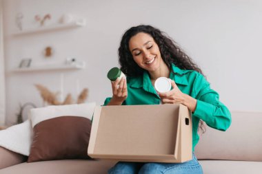 Mutlu Bayan Tutucu Skincare Kozmetik Ürünleri Evde Koltukta Oturan Başarılı Güzellik Dükkanı 'ndan sonra kutuları açıyor. Ticaret ve Teslimat Konsepti