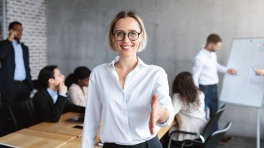 Modern Ofiste Ayakta Duran Kameraya El sıkışmak için el sıkışan kadın İK müdürü. Kariyer Teklifi, İşe Alma ve İstihdam, İnsan Kaynakları Konsepti. Seçici Odaklanma