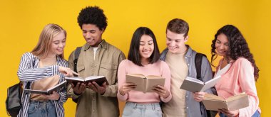 Ortak çalışma ve sınavlar ya da testler ve takım çalışması için hazırlık. Modern meşgul, neşeli, çok kültürlü öğrenciler kitap ve soyutlamalar okuyor, turuncu arka planda izole edilmiş, fotokopi alanı, stüdyo çekimi