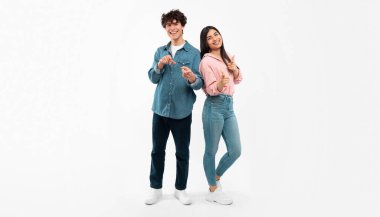 Seni seçiyoruz. Neşeli Genç Çift, Beyaz Stüdyo Arkaplanının Üzerinde Kamerada Parmak Gösteriyor. Sırada siz varsınız, reklam afişi. Tam Uzunluk Çekimi, Panorama