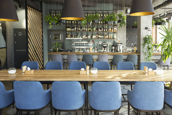 Modern cafe with places for rest and eating with big counter, cozy interior