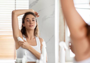 Terleme Karşıtı Silahları Uygulayan Çekici Kadın Ter Koruması Ayakta Durarak Modern Tuvalette Silah Pozisyonu Veriyor. Koltukaltı Cilt Bakımı ve Hijyen Rutini Konsepti