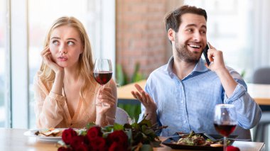 Romantik bir buluşma sırasında akıllı telefondan konuşan genç adam, kız arkadaşı kafede sıkılmış hissediyor. Milenyum kadını sıkıcı bir randevuda erkek arkadaşının telefonda konuşmayı kesmesini bekliyor.